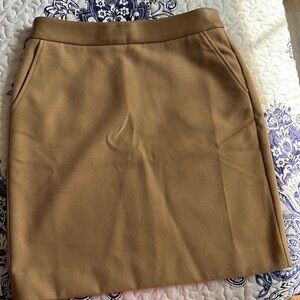 Above the knee camel skirt with "leather" accent at the waistband.